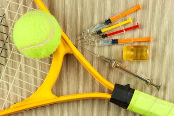 Tennis racket and ball. Anabolic steroids in tennis. Doping in sports.