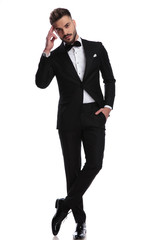 elegnat man in tuxedo making a military salute