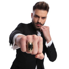 elegant man in fight position is throwing a punch