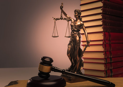 law books, justice statue and wooden gavel
