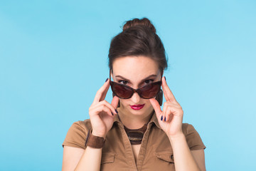 Portrait of a woman with glasses on a blue background