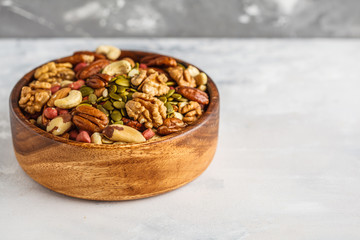 A variety of nuts and seeds in a wooden bowl, Food background, vegan healthy food concept. Copy space
