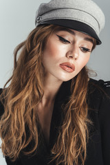 Fashion portrait of an attractive stylish curly brown haired woman