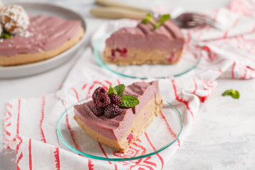Pink berry caramel raw vegan cheesecake with coconut sweet raw balls. Healthy vegan food concept.