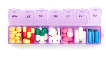Daily pill box with medical pills isolated on white background. Top view. Flat lay