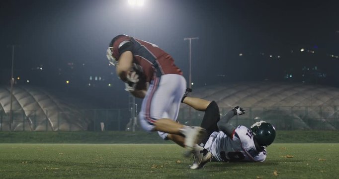 American football player tackles opponent