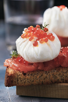Useful breakfast with poached egg, caviar and red fish