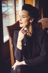 Beautiful stylish lady in vintage look, retro or vintage style in modern city life  