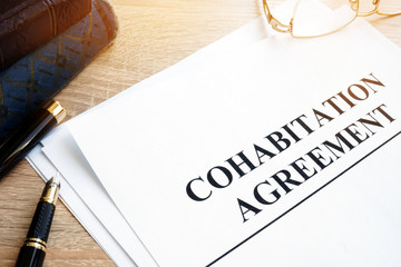 Cohabitation Agreement and books on a table. - obrazy, fototapety, plakaty