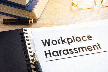 Documents about workplace harassment in an office.