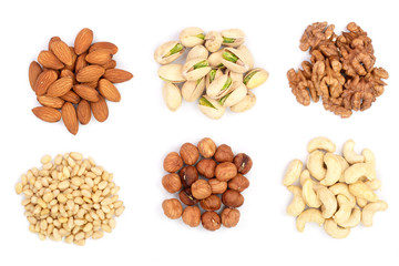mixed of nuts heap isolated on white background. Almonds, cashews, hazelnuts, pine nuts and...
