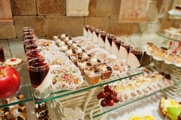 Close-up photo of a huge variety of fruits and sweet desserts on the wedding banquet.
