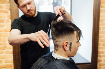 man getting trendy haircut at barber shop.