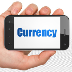 Money concept: Hand Holding Smartphone with blue text Currency on display, 3D rendering