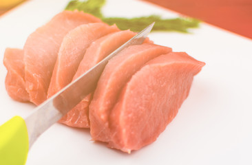 Pork fillets slice into pieces on a white background. Toned.