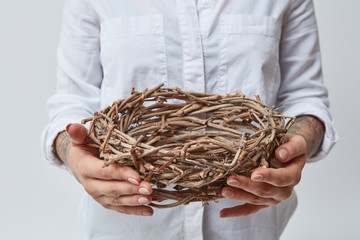 Young girl holding a nest of branches