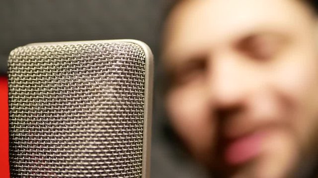 Singer emotionally writing a song in recording studio