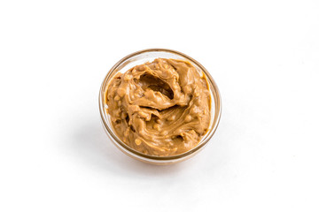 peanut pasta in glass bowl on white background