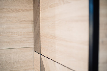 Wooden beige tile background. Close-up of newly installed tile with natural colored.