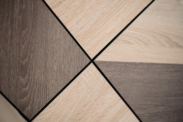 Wooden beige tile background. Close-up of newly installed tile with natural colored.