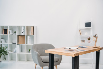 modern office interior with papers and digital tablet on table