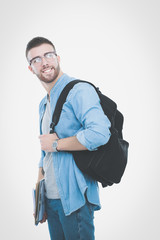 A male student with a school bag holding books isolated on white background. Education opportunities. College student.