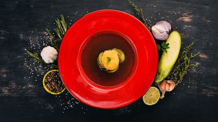 Ratatouille soup with zucchini. Top view. On a black wooden background. Copy space.