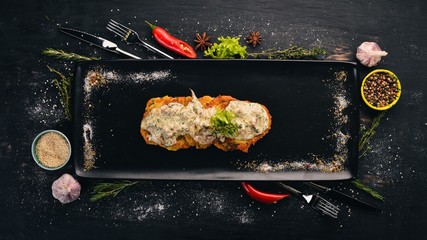 Potato pancakes with pork. Hot appetizers. Top view. On a black wooden background. Copy space.