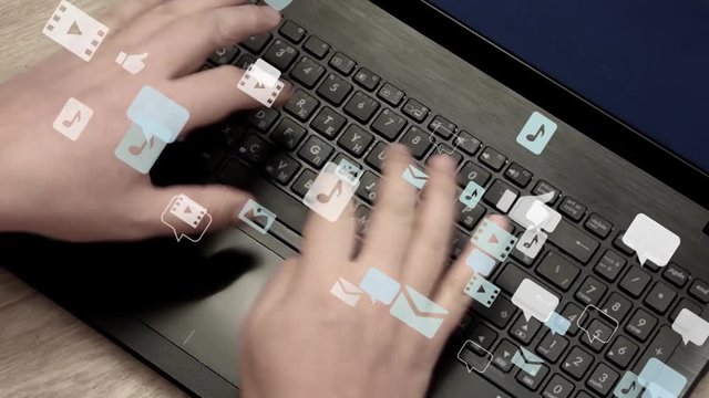 Caucasian man hands rapidly typing on laptop keyboard. Lot of speech bubbles, image icons, sound and video icons fly away. Communication in social networks, chatting. Real video with 3d animation.