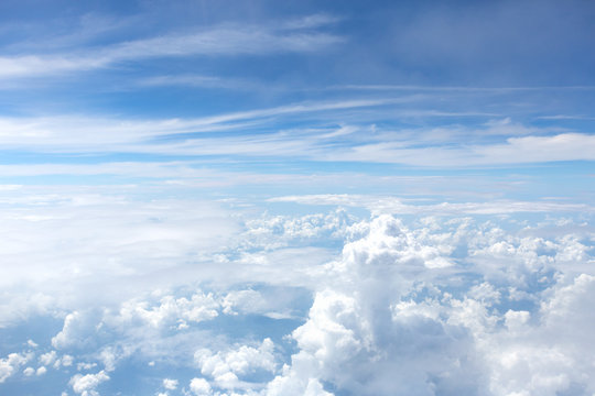 Aerial view on clouds and blue sky from airplane window © Glebstock