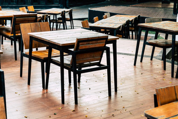 empty wood table and chair in outdoor restaurant