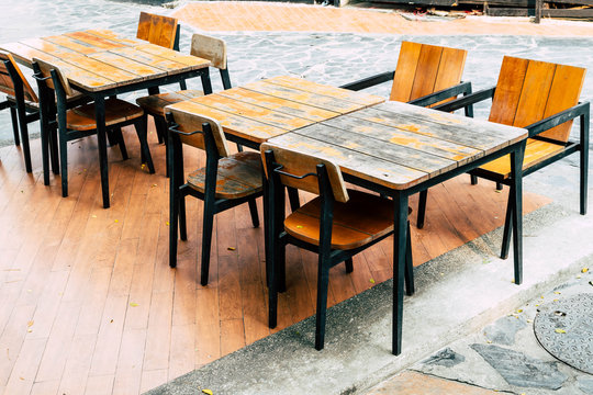 empty wood table and chair in outdoor restaurant