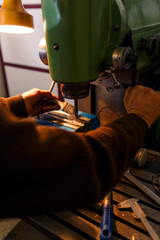 Lathe machine drilling metal in workshop.