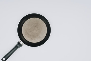 top view of empty frying pan isolated on grey