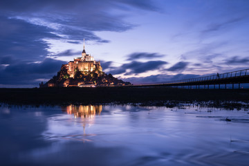 Mont Saint Michael with water reflection during night time
