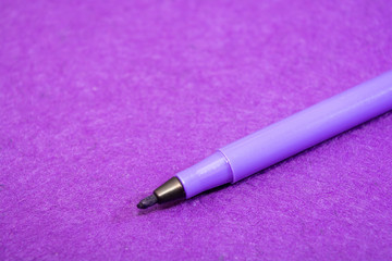 Violet felt pen on a purple felt background with space for text. Back to school. Art lessons.