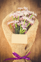 Delicate flowers and empty greeting card.