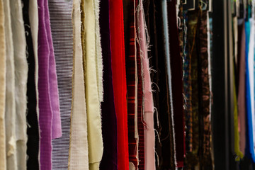 Closeup of colorful scarves hanging in the market.