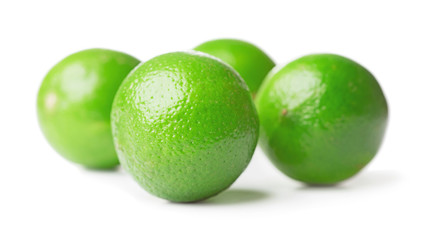 four limes isolated on white background