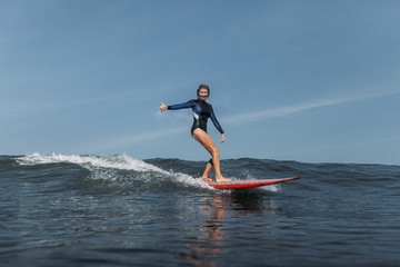 sports woman surfing wave in ocean