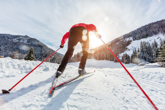 Cross-country skiing. Young man doing outdoor exercise.