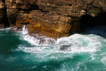 Fototapeta na wymiar Sea waves hitting rock cliffs at Boca do Inferno, Cascais, Portugal