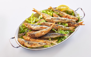 Crisp fried sardines in batter on fresh lettuce