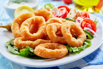 Crisp fried golden squid rings with salad