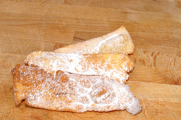 Carnival Italian frappe, homemade, on wooden kitchen board, from above