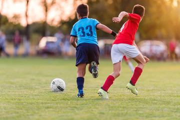 Obraz premium Boys kicking football