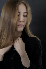 Beauty Woman Face. Portrait of beautiful Mongolian young female on black background. 