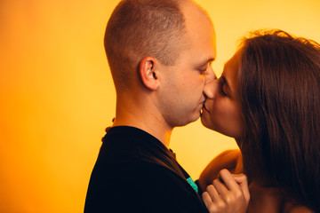 Girl and boy on the background of a sunset color