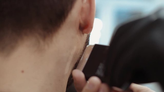 Triangle trimmer in barber shop. Men's haircut and body care.