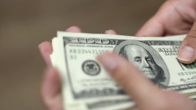 Hands counting dollars